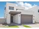 Contemporary two-story home with desert landscaping and gray two-car garage under a bright blue sky at 10253 E Ursula Ave, Mesa, AZ 85212