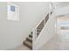 A bright stairway features carpeted steps, a white banister, and leads to the home's upper level at 10253 E Ursula Ave, Mesa, AZ 85212