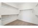 Bright walk-in closet featuring white walls, shelving, and neutral carpet at 10253 E Ursula Ave, Mesa, AZ 85212