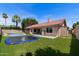 Spacious backyard featuring a pool, trampoline, artificial grass, and outdoor grill area at 11131 E Becker Ln, Scottsdale, AZ 85259