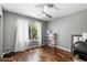 Bright bedroom with hardwood floors and a window offering natural light at 11131 E Becker Ln, Scottsdale, AZ 85259