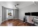 Well-lit bedroom with hardwood floors and a workspace at 11131 E Becker Ln, Scottsdale, AZ 85259