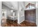 Open-concept dining area with decorative light fixture, and wood floors at 11131 E Becker Ln, Scottsdale, AZ 85259