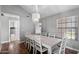 Dining room featuring wood floors, a chandelier, and white dining set at 11131 E Becker Ln, Scottsdale, AZ 85259