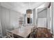 Dining room with chandelier, wood floors, and direct access to the living area at 11131 E Becker Ln, Scottsdale, AZ 85259