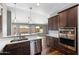 Bright kitchen with stainless steel appliances, a breakfast bar, and an open view of the living area at 11131 E Becker Ln, Scottsdale, AZ 85259