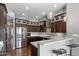 Modern kitchen with stainless steel appliances, dark wood cabinets, and a breakfast bar at 11131 E Becker Ln, Scottsdale, AZ 85259