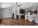 Spacious living room with hardwood floors, ceiling fans, and an open layout to the kitchen at 11131 E Becker Ln, Scottsdale, AZ 85259