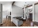 Spacious living room featuring a gray sectional sofa, wood floors, and high ceilings at 11131 E Becker Ln, Scottsdale, AZ 85259