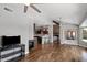 Open floor plan showcasing the living room with hardwood floors, fireplace, and access to kitchen at 11131 E Becker Ln, Scottsdale, AZ 85259