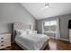 Bright main bedroom featuring a plush bed, wood floors, and a window offering natural light at 11131 E Becker Ln, Scottsdale, AZ 85259