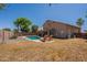 Backyard featuring pool, lounge chairs, and home with covered outdoor dining at 1125 S Larkspur St, Gilbert, AZ 85296