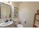 Well-lit powder room featuring a pedestal sink and decorative wall art at 1125 S Larkspur St, Gilbert, AZ 85296
