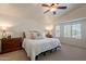 Inviting bedroom with a large bed, side tables, bay window with shutters, and neutral tones at 1125 S Larkspur St, Gilbert, AZ 85296