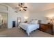 Relaxing bedroom with large bed, mirror, lamps, and soft, neutral decor at 1125 S Larkspur St, Gilbert, AZ 85296