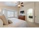 Comfortable bedroom with a bed, bay window, dresser, and bathroom view at 1125 S Larkspur St, Gilbert, AZ 85296