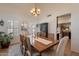 Inviting dining room with chandelier, large windows, and a view of the kitchen area at 1125 S Larkspur St, Gilbert, AZ 85296