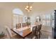 Bright dining room with wood table, shuttered windows, and elegant chandelier at 1125 S Larkspur St, Gilbert, AZ 85296