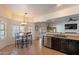 Open-concept kitchen with breakfast nook, stainless steel appliances, and lots of natural light at 1125 S Larkspur St, Gilbert, AZ 85296