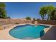 Backyard swimming pool surrounded by desert landscaping and block wall fence at 1125 S Larkspur St, Gilbert, AZ 85296