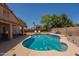 Backyard pool with lounge chairs and manicured green lawn in private fenced yard at 1125 S Larkspur St, Gilbert, AZ 85296