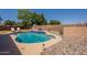 Backyard swimming pool with desert landscaping and a block wall fence at 1125 S Larkspur St, Gilbert, AZ 85296