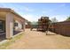 Spacious backyard features a wooden playset and a fenced-in yard at 11921 W Flores Dr, El Mirage, AZ 85335
