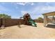 Spacious backyard featuring a playset for , perfect for Gathering fun and outdoor activities at 11921 W Flores Dr, El Mirage, AZ 85335