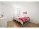 Bedroom with metal frame bed and pink accents at 11921 W Flores Dr, El Mirage, AZ 85335