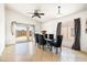 A dining area that features a modern table set and a ceiling fan at 11921 W Flores Dr, El Mirage, AZ 85335