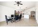 Open-concept dining room featuring stylish black chairs, modern table and adjacent kitchen at 11921 W Flores Dr, El Mirage, AZ 85335