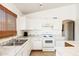 A kitchen featuring white cabinets, laminate counter tops, and tile floors at 11921 W Flores Dr, El Mirage, AZ 85335