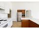 Bright kitchen with stainless steel refrigerator, oven, and white marble countertops at 11921 W Flores Dr, El Mirage, AZ 85335