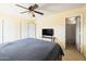Bedroom features a ceiling fan, television, and attached bathroom at 11921 W Flores Dr, El Mirage, AZ 85335