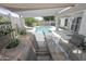 Outdoor dining area with a view of the pool and beautifully landscaped backyard at 1210 W Betty Elyse Ln, Phoenix, AZ 85023