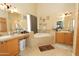 Spacious bathroom with dual vanities and a soaking tub at 1210 W Betty Elyse Ln, Phoenix, AZ 85023