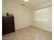 Neutral bedroom with tile floors, ceiling fan, and natural light, awaiting your personal touch and decor at 1210 W Betty Elyse Ln, Phoenix, AZ 85023