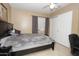 Well kept bedroom with a queen size bed, ceiling fan, and closet space, perfect for relaxation and storage at 1210 W Betty Elyse Ln, Phoenix, AZ 85023