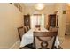 Dining room showcases a chandelier and curio cabinet for displaying special items for formal or informal events at 1210 W Betty Elyse Ln, Phoenix, AZ 85023