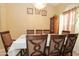 Dining area features seating for eight under a chandelier with a large window to bring in extra daylight at 1210 W Betty Elyse Ln, Phoenix, AZ 85023