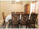 A beautifully staged dining room features seating for eight and a decorative chandelier for an elegant touch at 1210 W Betty Elyse Ln, Phoenix, AZ 85023