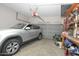 Spacious two-car garage featuring an automatic door, gray paint, and shelving units for maximum storage at 1210 W Betty Elyse Ln, Phoenix, AZ 85023