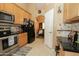 The kitchen boasts a tile backsplash, stainless steel appliances and lots of cabinet space for optimal storage at 1210 W Betty Elyse Ln, Phoenix, AZ 85023