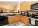 Open concept kitchen with granite countertops, stainless steel appliances, and a breakfast bar with seating at 1210 W Betty Elyse Ln, Phoenix, AZ 85023