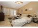 Living room featuring a large sectional sofa, ceiling fan, and patio doors at 1210 W Betty Elyse Ln, Phoenix, AZ 85023