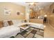 Open living area with tile floors, a large sectional, and views to the kitchen at 1210 W Betty Elyse Ln, Phoenix, AZ 85023