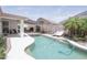 Inviting backyard pool area featuring mature palm trees and comfortable lounge chairs at 1210 W Betty Elyse Ln, Phoenix, AZ 85023