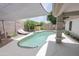 Relaxing pool with a sunshade, lounge chair, and privacy landscaping at 1210 W Betty Elyse Ln, Phoenix, AZ 85023