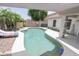 Private backyard pool, lush greenery, and shaded patio for outdoor enjoyment at 1210 W Betty Elyse Ln, Phoenix, AZ 85023