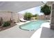Backyard pool area with a lounge chair shaded by a stretched canvas at 1210 W Betty Elyse Ln, Phoenix, AZ 85023